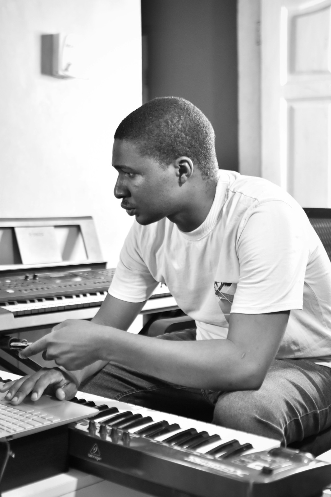 Producer working at a keyboard in the studio