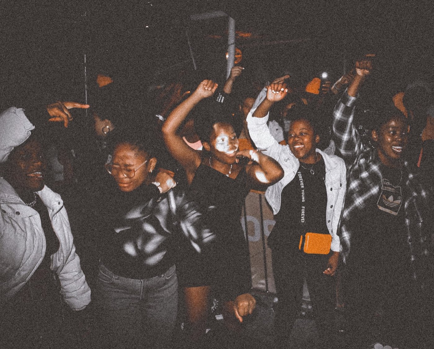 A young crowd dancing at a concert